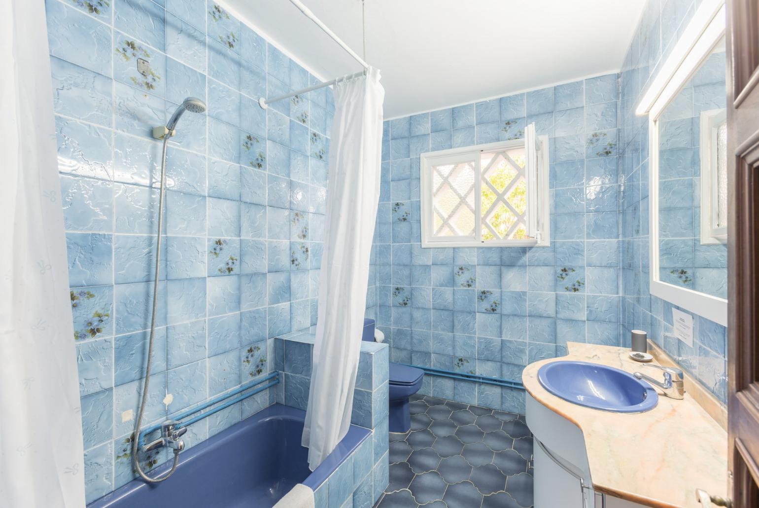 Family bathroom with bath and overhead shower