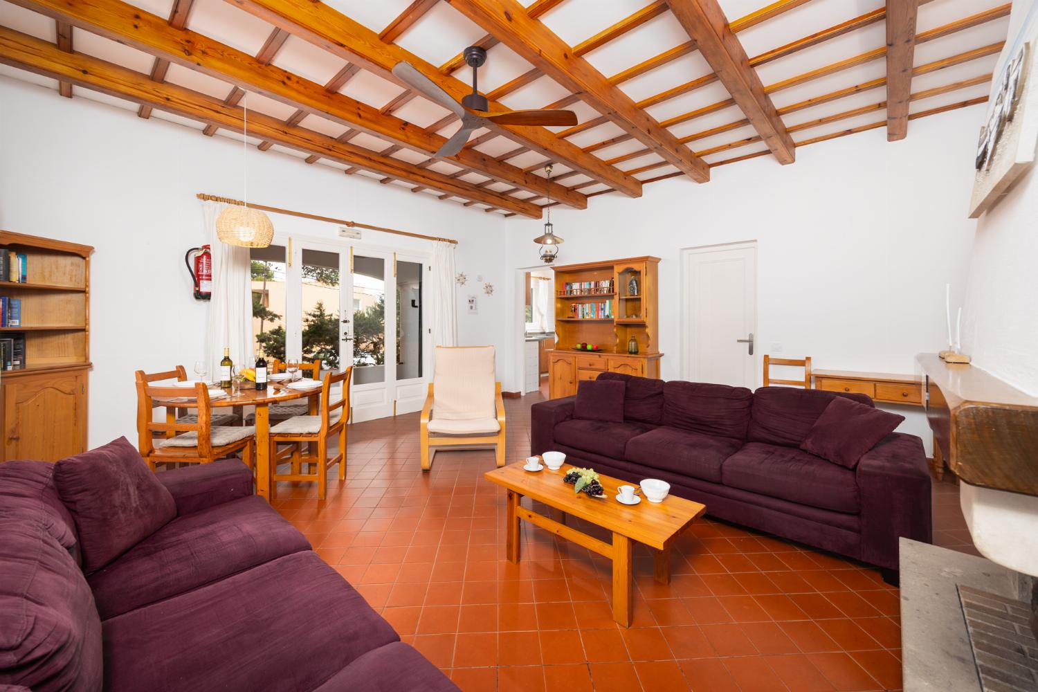 Living room with sofas, dining area, ornamental fireplace, WiFi internet, and satellite TV