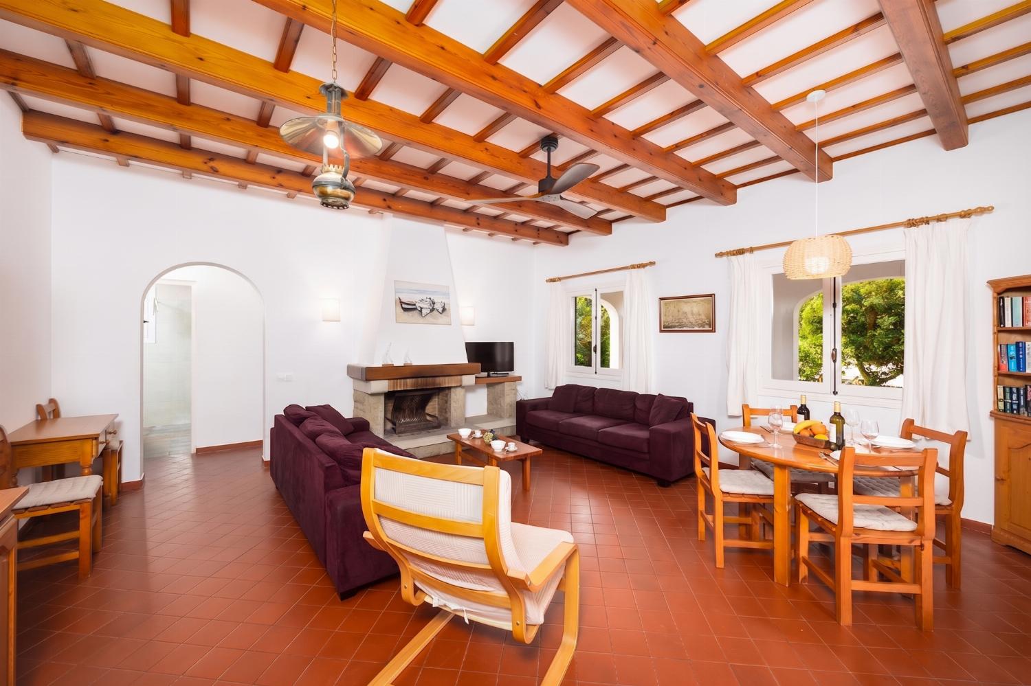 Living room with sofas, dining area, ornamental fireplace, WiFi internet, and satellite TV