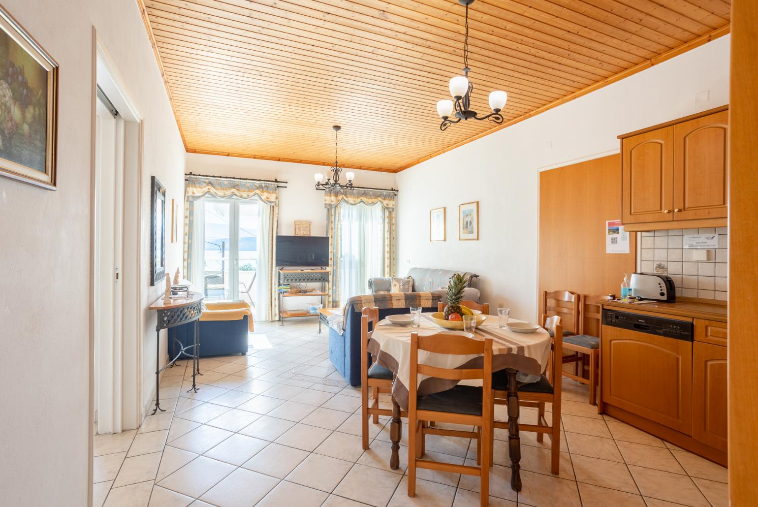 Open-plan living room with sofas, dining area, kitchen, WiFi internet, satellite TV, and sea views