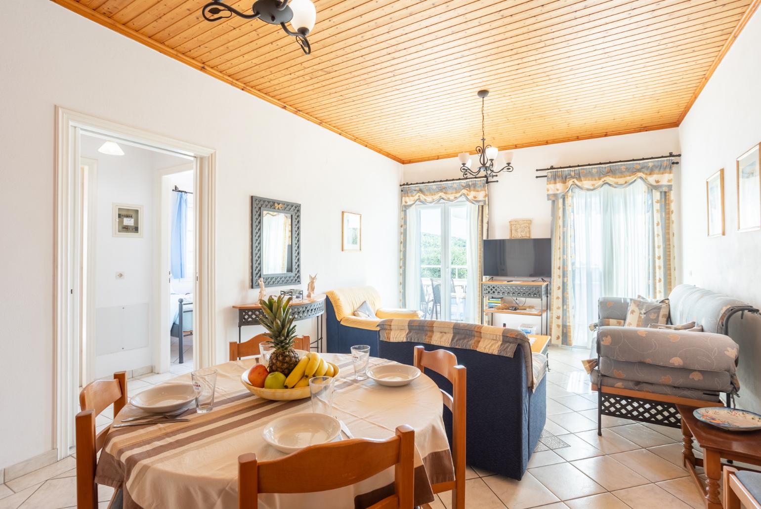 Open-plan living room with sofas, dining area, kitchen, WiFi internet, satellite TV, and sea views