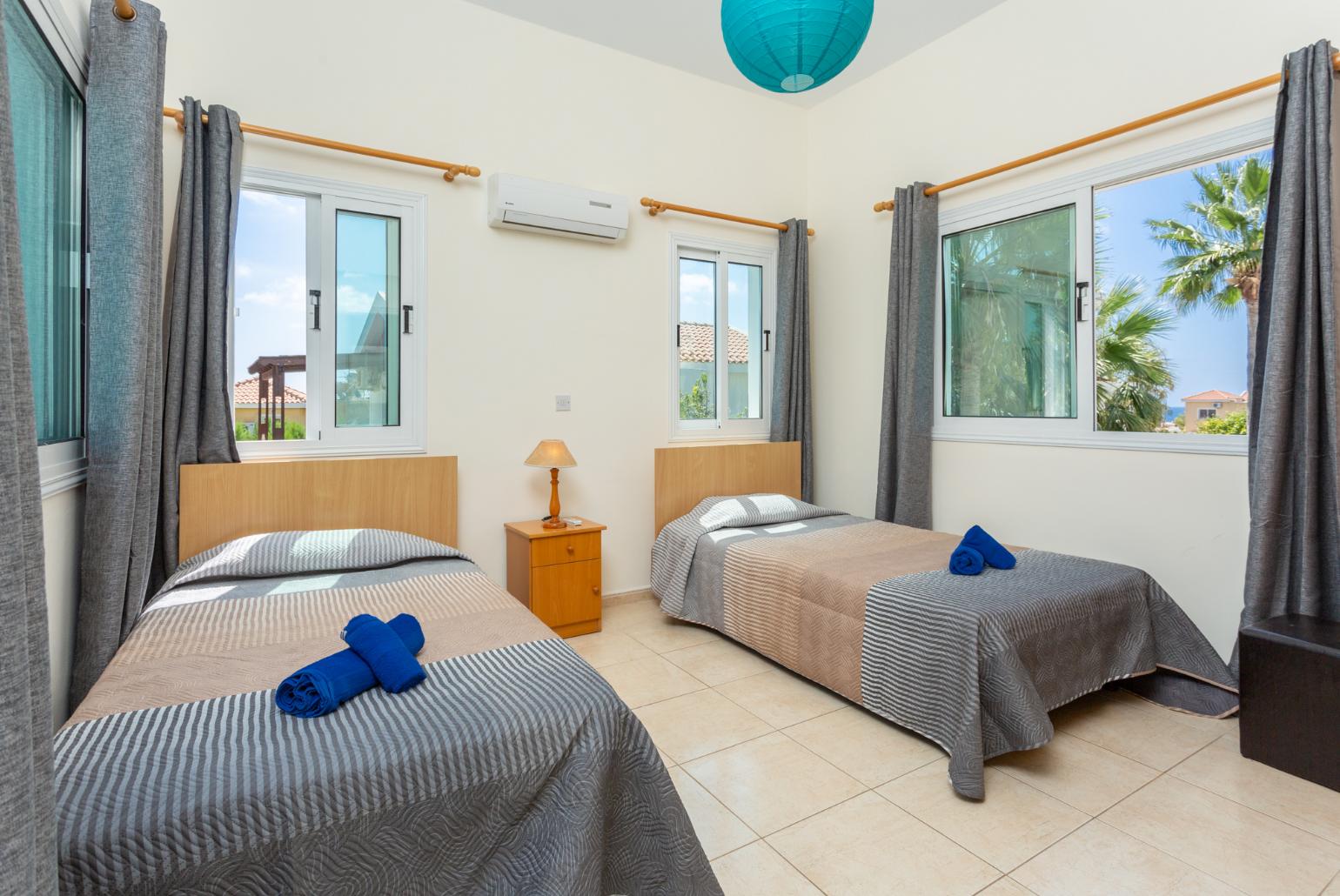 Twin bedroom with en suite bathroom, A/C, and upper terrace access