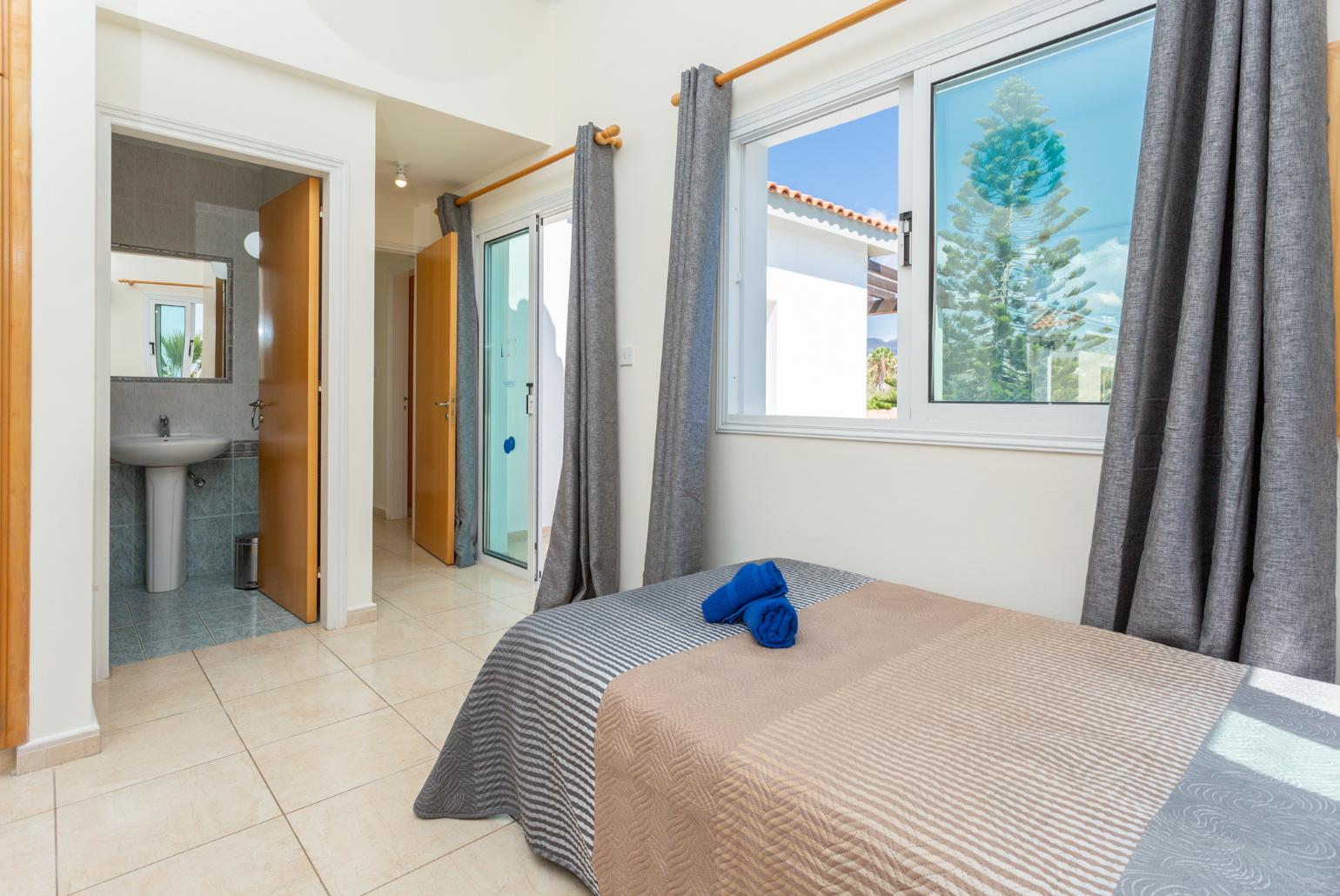 Twin bedroom with en suite bathroom, A/C, and upper terrace access