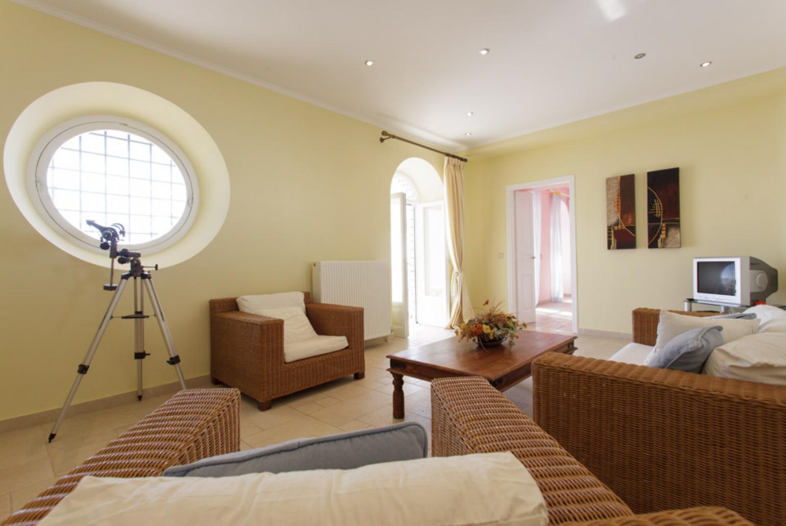 Living area with WiFi, ornamental fireplace, TV, DVD player and terrace access