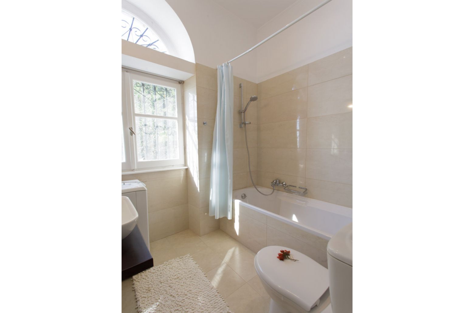 Bathroom with bath and overhead shower