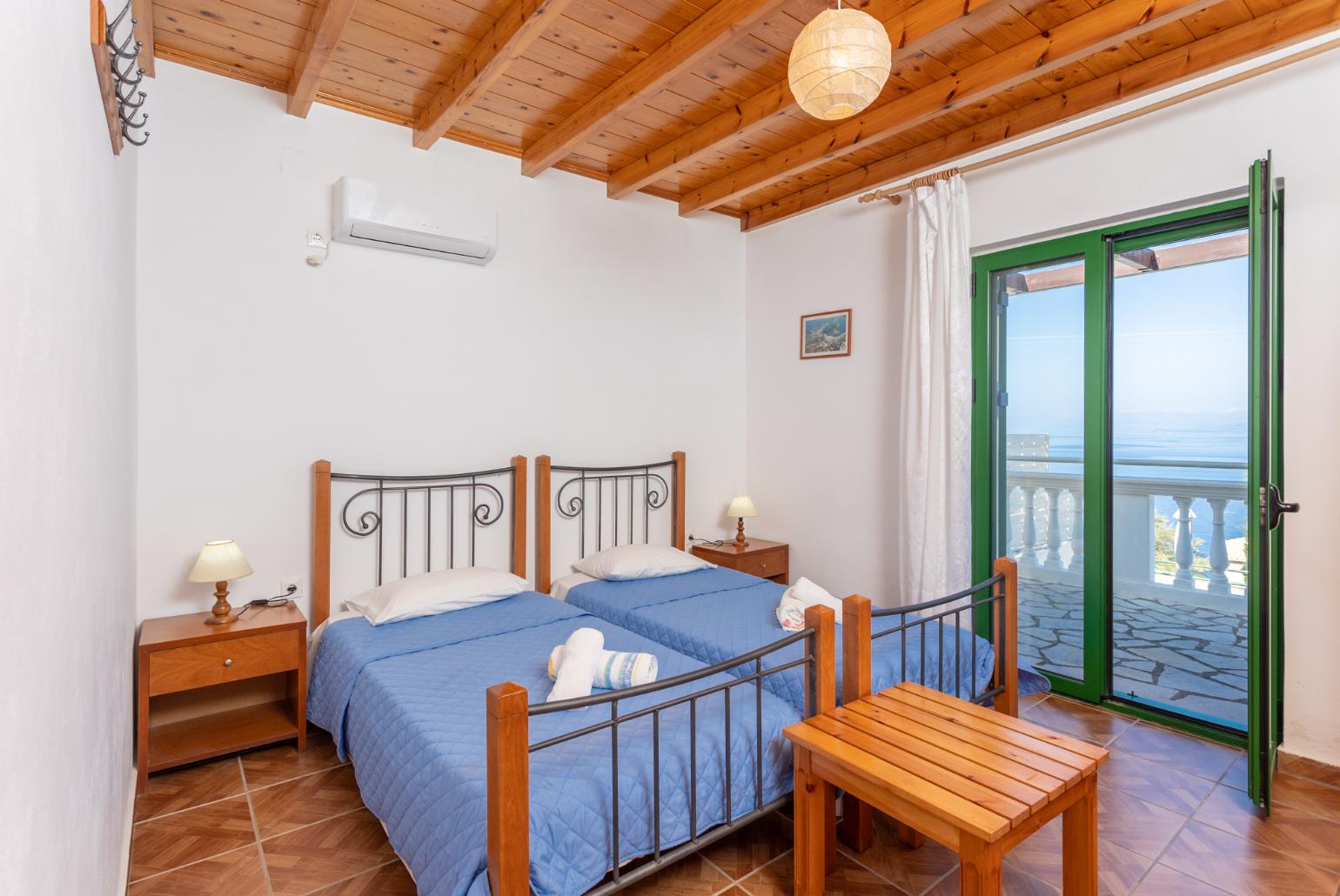 Twin bedroom with A/C, sea views, and terrace access