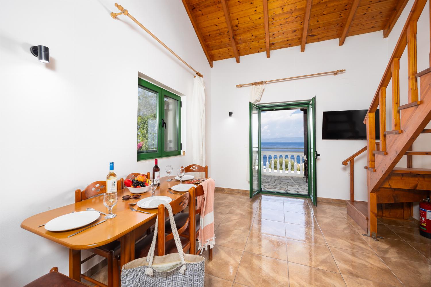 Open-plan living room with dining area, kitchen, A/C, WiFi internet, satellite TV, and sea views