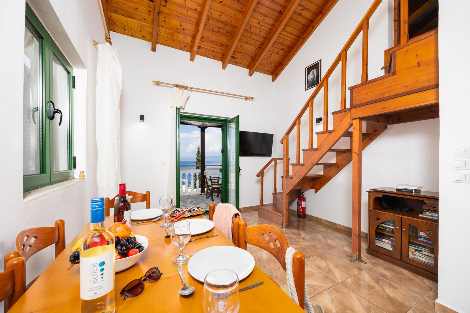 Open-plan living room with dining area, kitchen, A/C, WiFi internet, satellite TV, and sea views