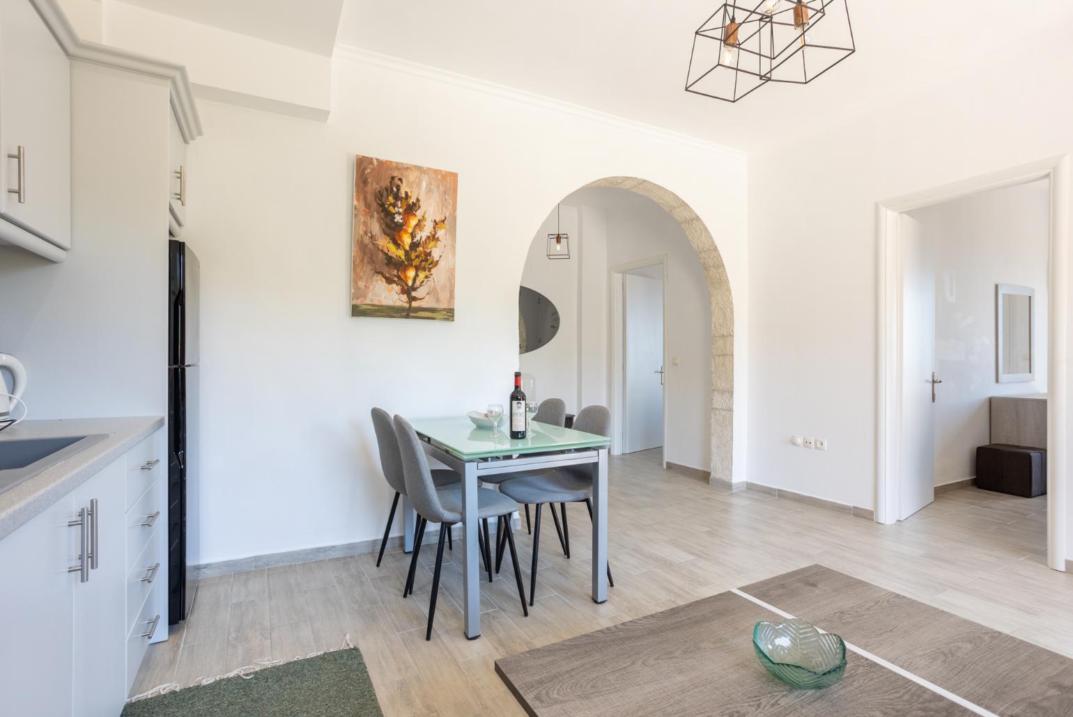 Open-plan living room with sofa, dining area, kitchen, WiFi internet, and terrace access