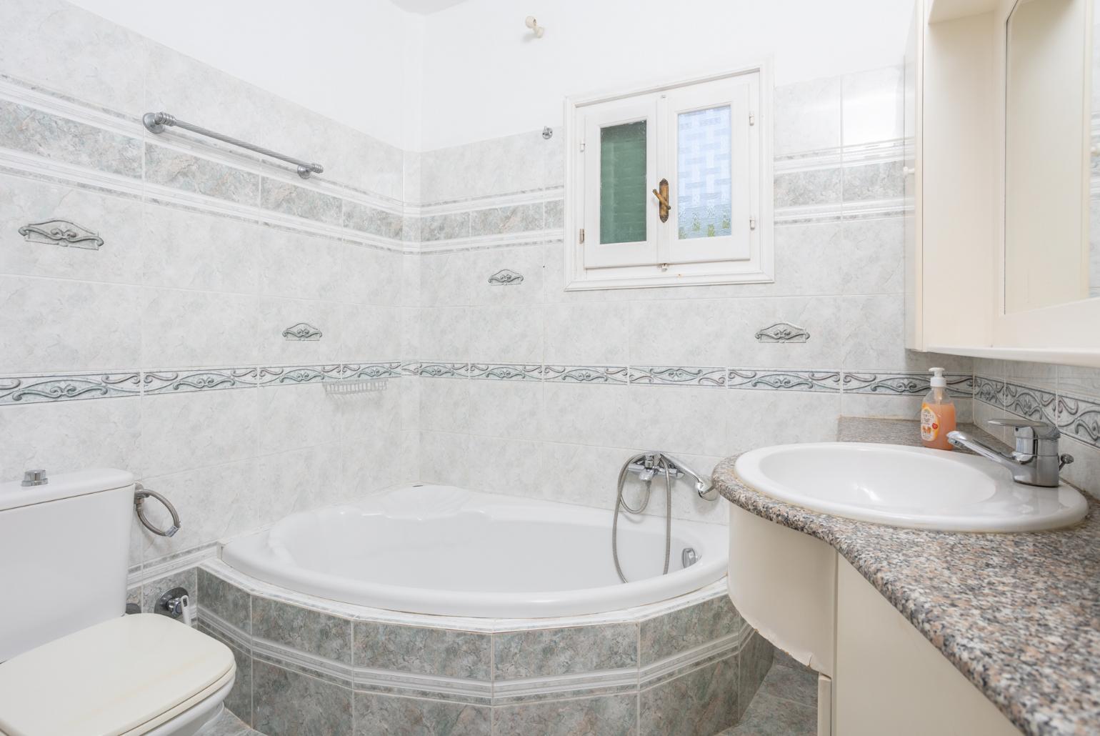 Family bathroom with bath and shower