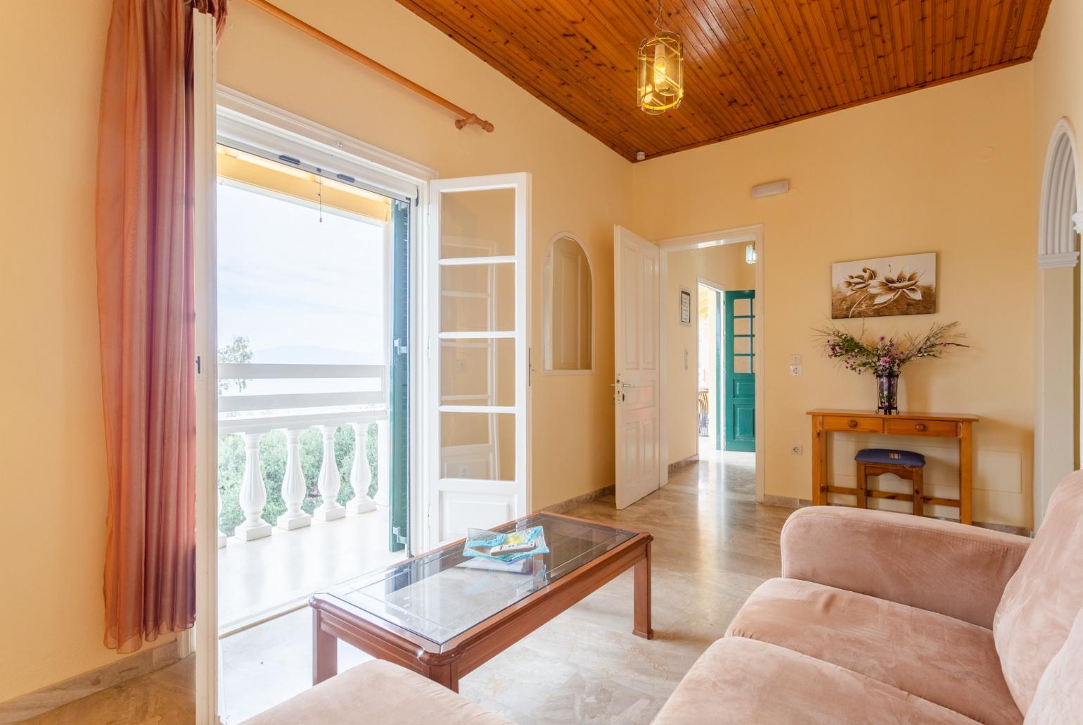 Living area with sofa, A/C, and balcony access with sea views