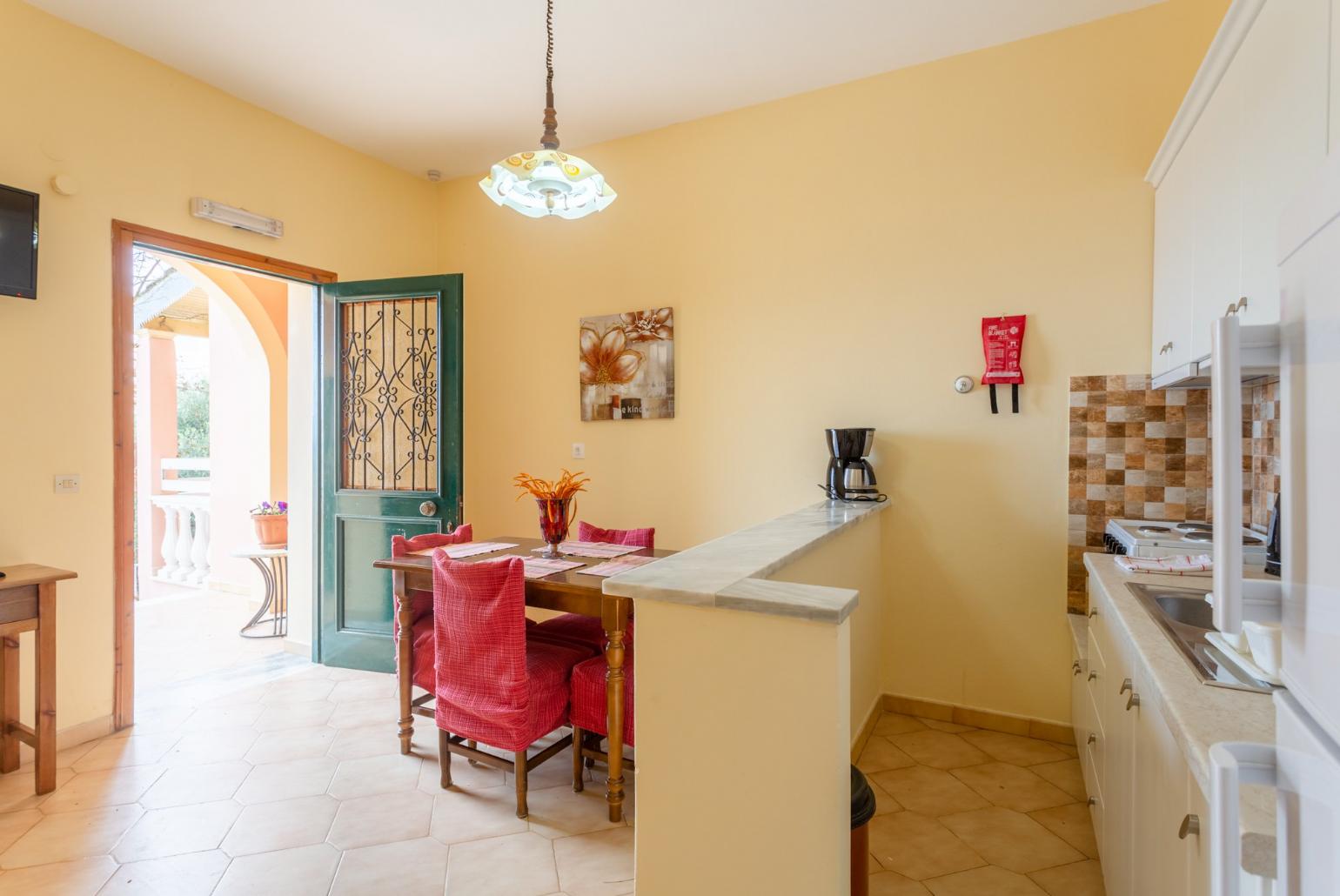 Living area with dining area, TV, kitchen, and terrace access