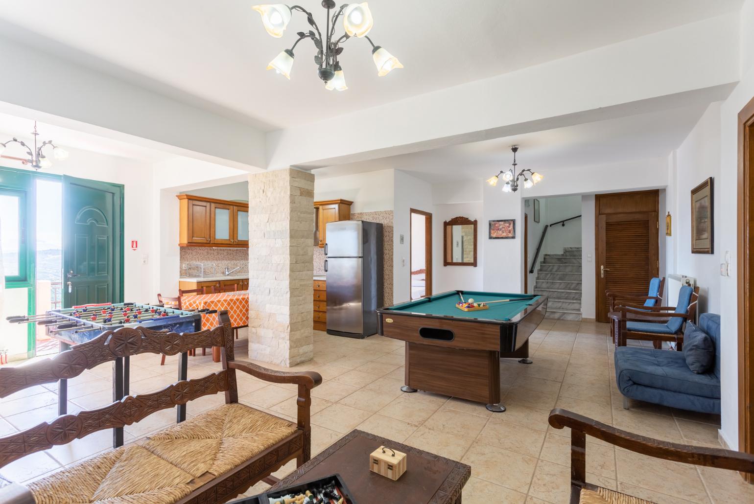 Second living room with sofas, dining area, kitchen, pool table, table football, ornamental fireplace, WiFi internet, satellite TV, and terrace access