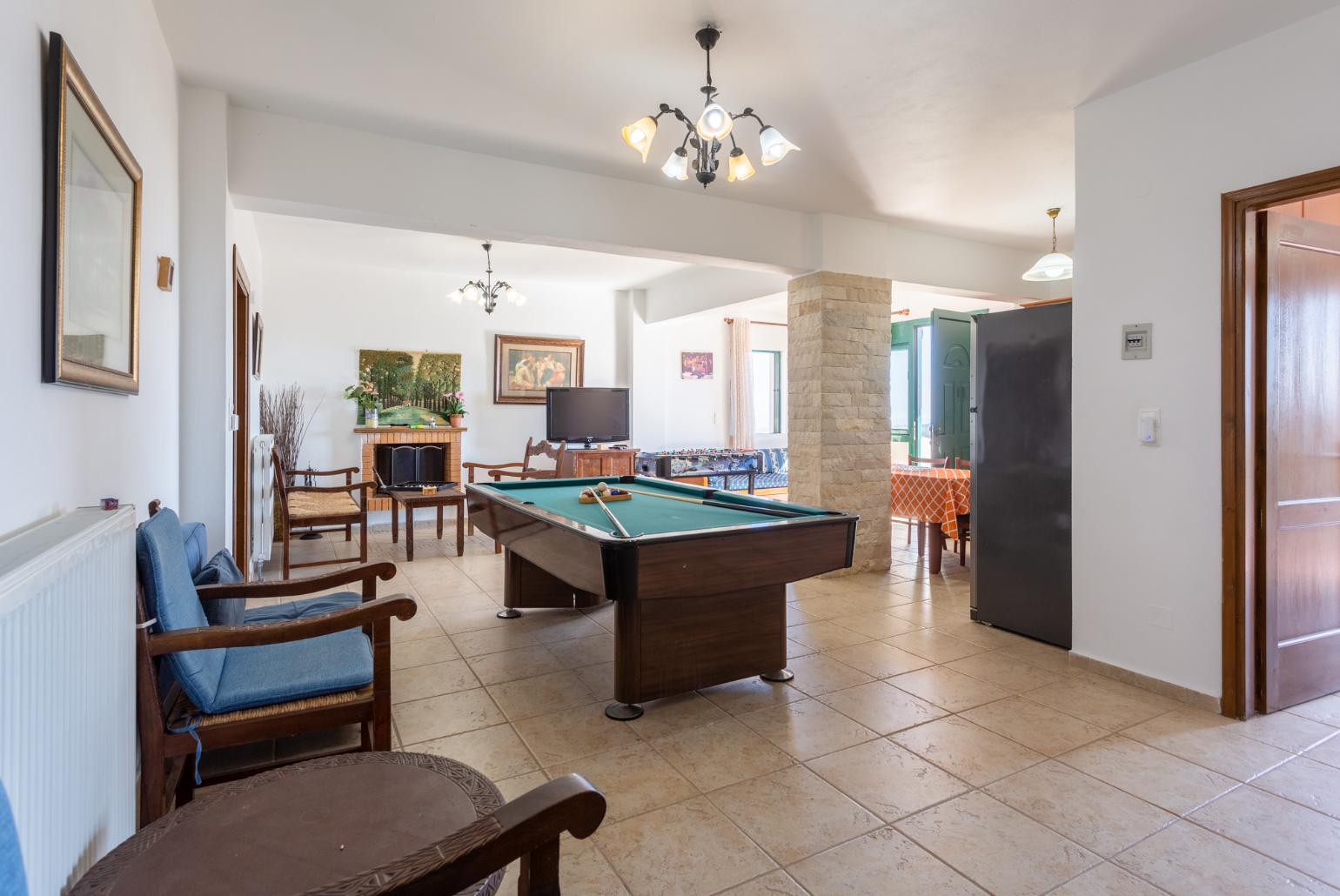 Second living room with sofas, dining area, kitchen, pool table, table football, ornamental fireplace, WiFi internet, satellite TV, and terrace access