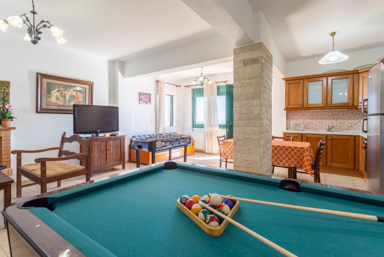 Second living room with sofas, dining area, kitchen, pool table, table football, ornamental fireplace, WiFi internet, satellite TV, and terrace access