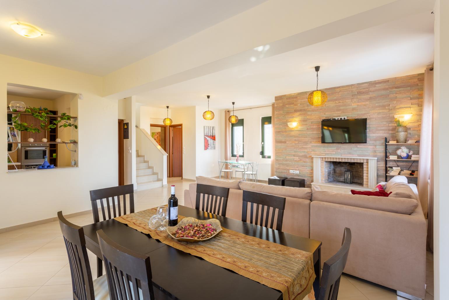 Living room with sofas, dining area, ornamental fireplace, WiFi internet, satellite TV, and terrace access