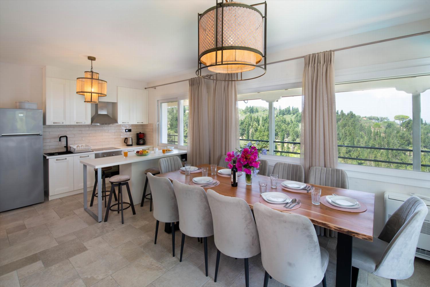 Equipped kitchen and dining table with panoramic sea views