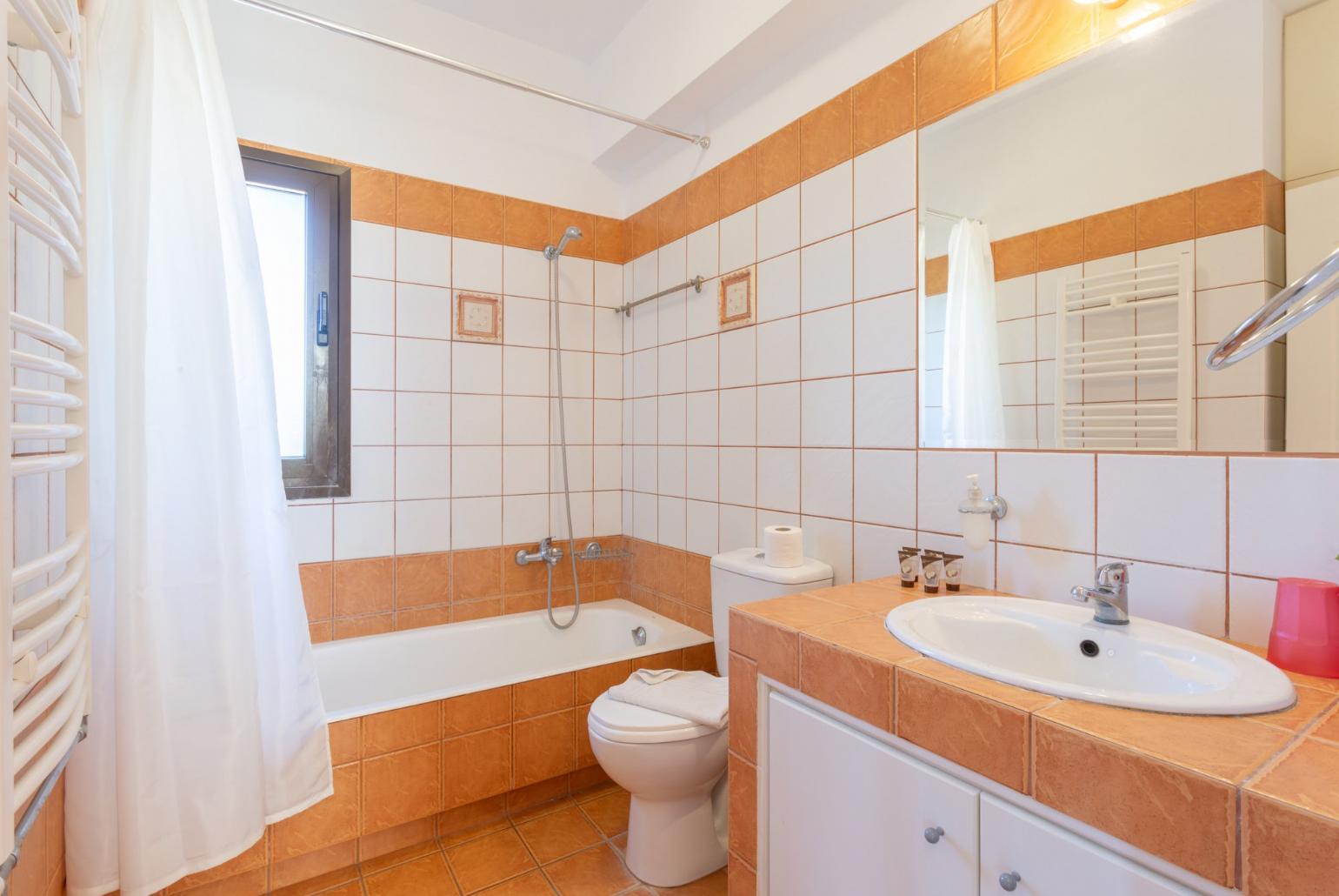 Family bathroom with bath and overhead shower