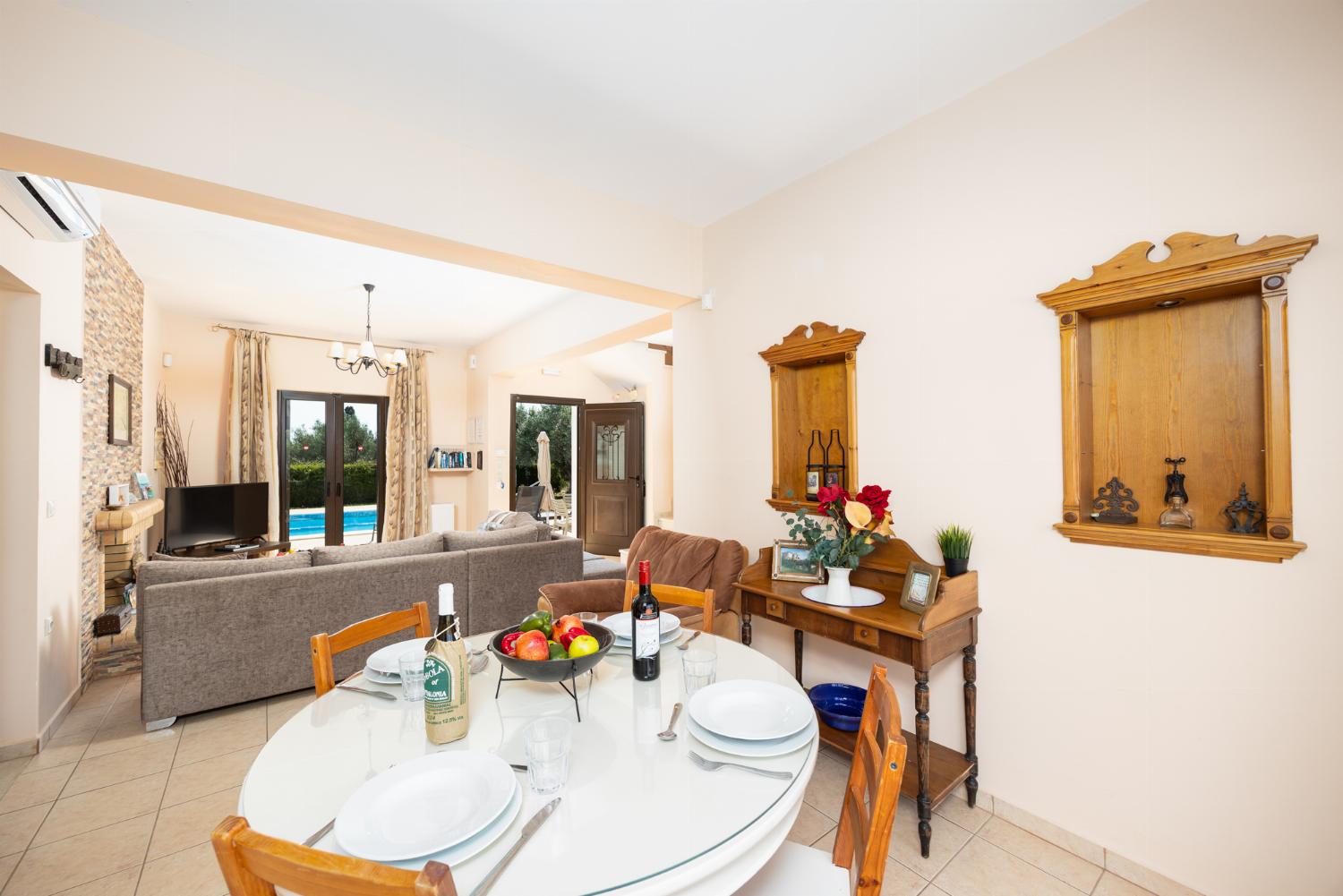 Open-plan living room with sofa, dining areas, kitchen, ornamental fireplace, A/C, WiFi internet, A/C, and satellite TV