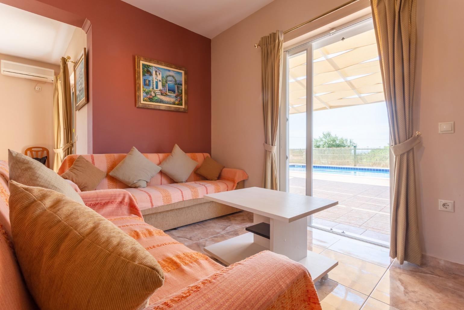 Open-plan living room with dining area, kitchen, terrace access, A/C, WiFi Internet, Satellite TV, and DVD player