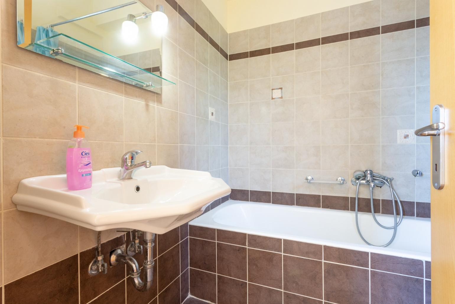 En suite bathroom with bath and overhead shower