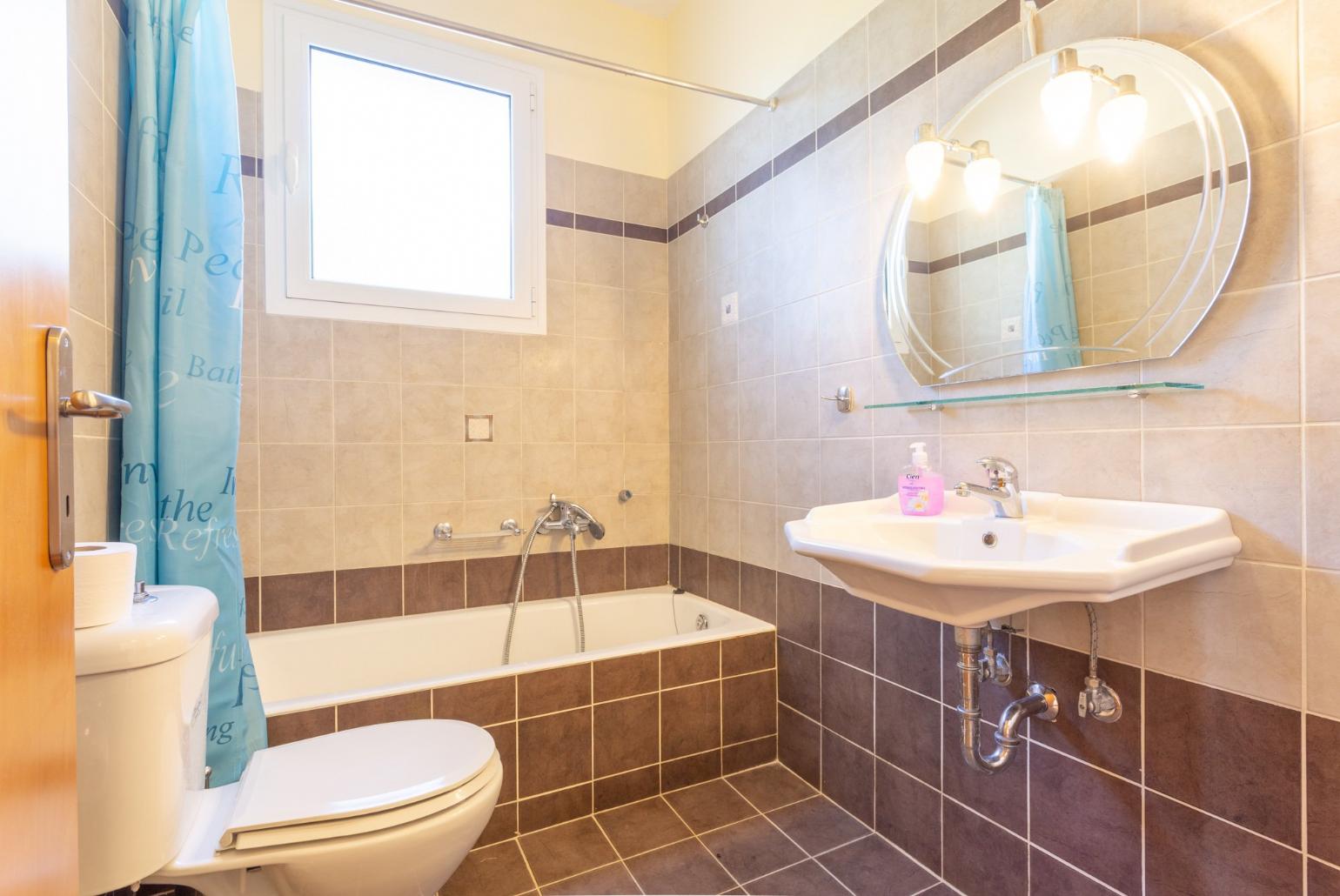 En suite bathroom with bath and overhead shower