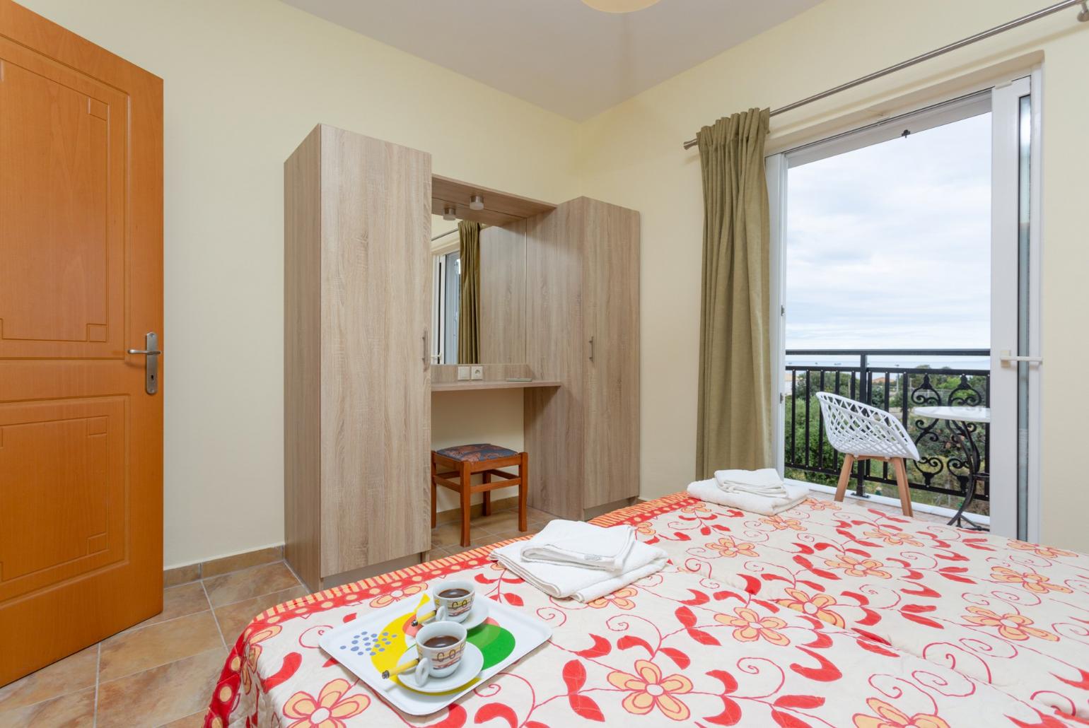 Twin bedroom with en suite bathroom, A/C, and balcony access