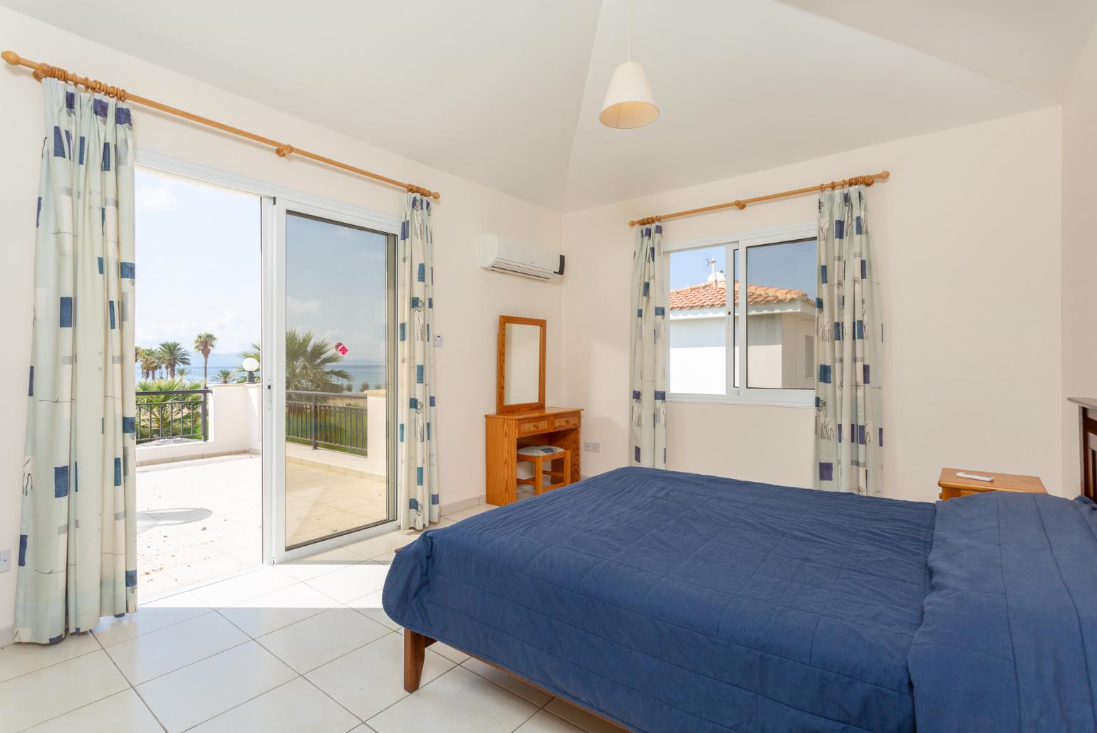 Double bedroom with en suite bathroom, A/C, and balcony access with sea views