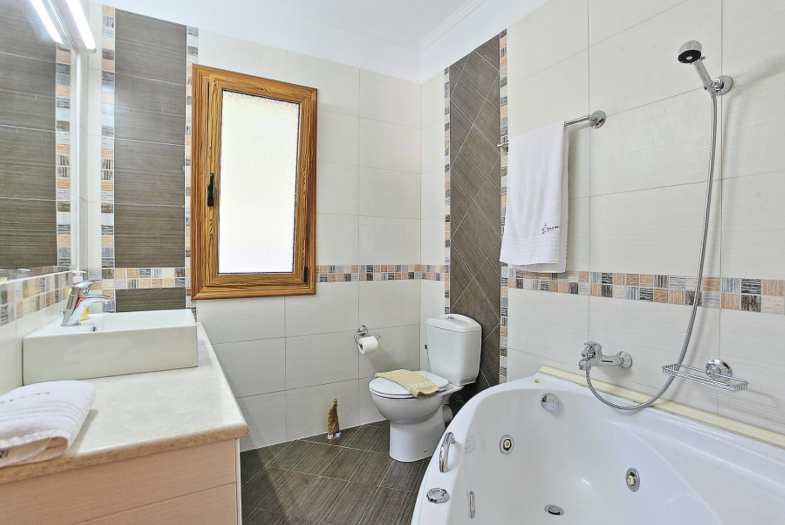 Bathroom with bath and overhead shower