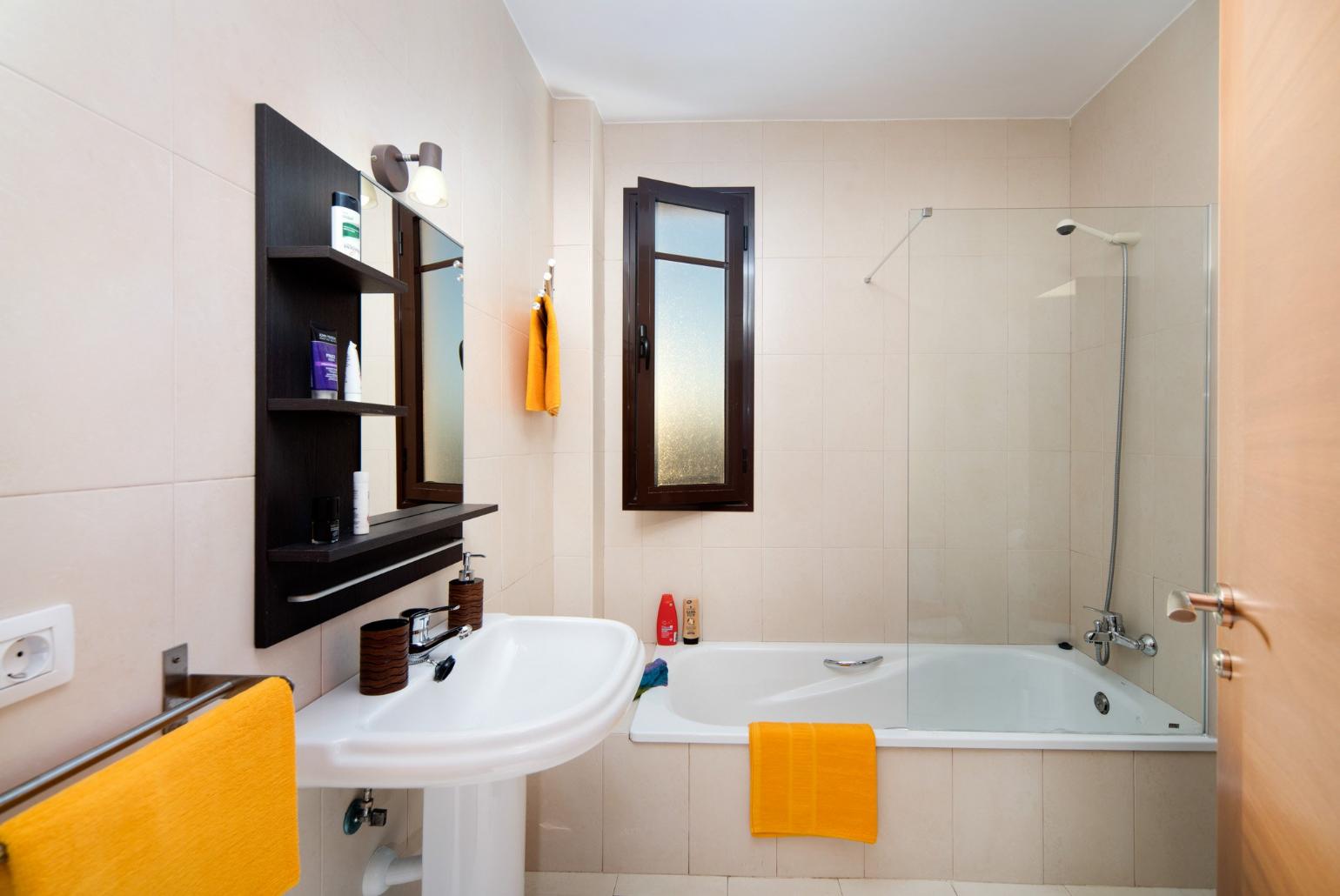 Bathroom with bath and overhead shower