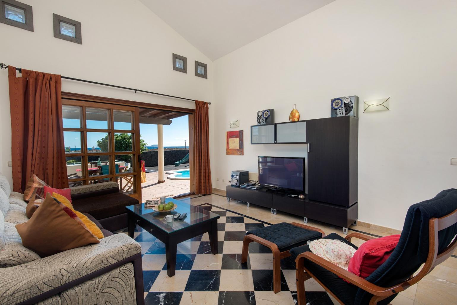 Living area with WiFi, TV, DVD player with terrace access