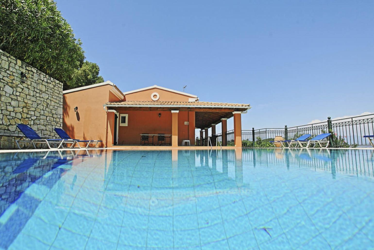 Private swimming pool with sun loungers