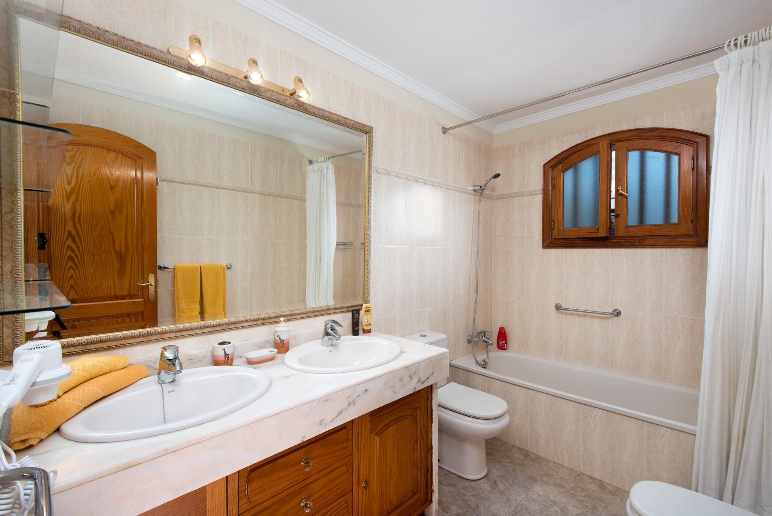 Bathroom with bath and overhead shower