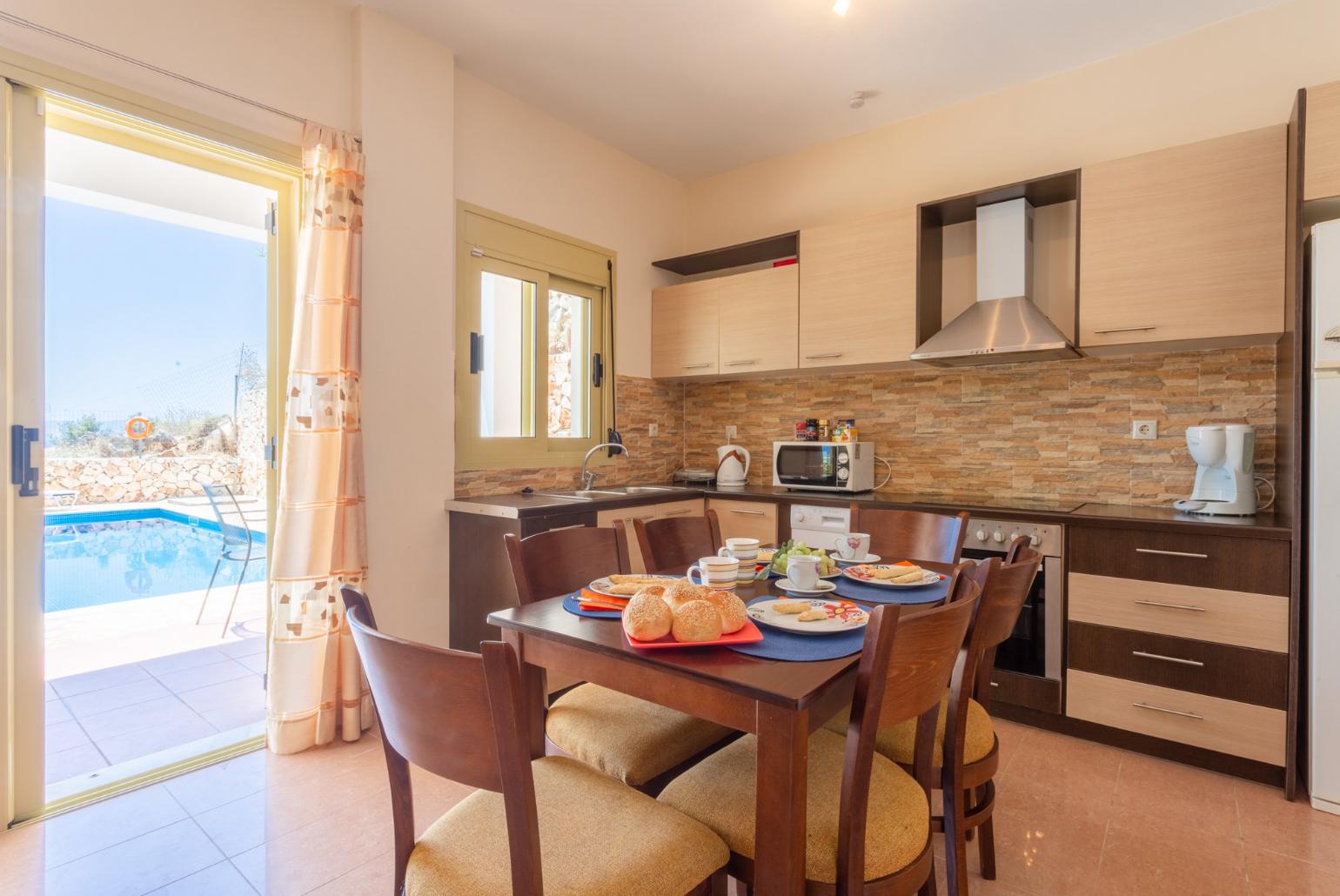 Open-plan living room with dining area, equipped kitchen, terrace access, WiFi Internet, Satellite TV, and DVD player 