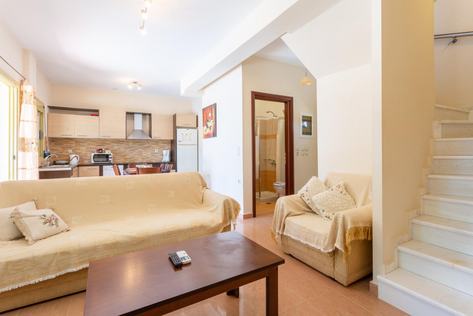 Open-plan living room with dining area, equipped kitchen, terrace access, WiFi Internet, Satellite TV, and DVD player 