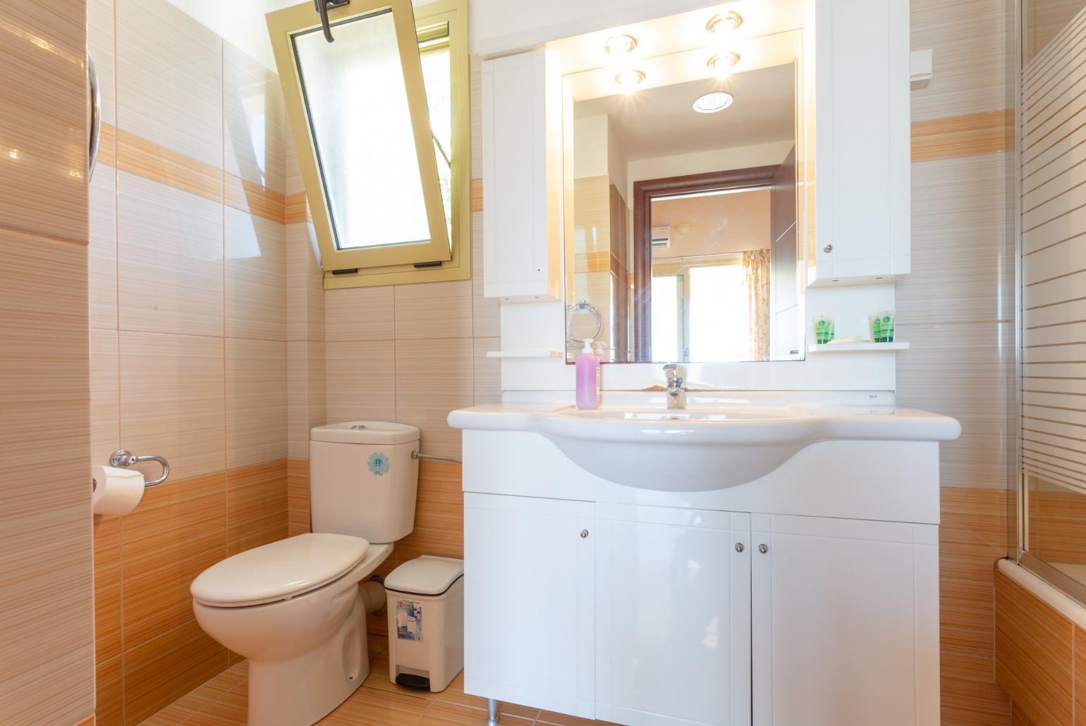 En suite bathroom with bath and overhead shower