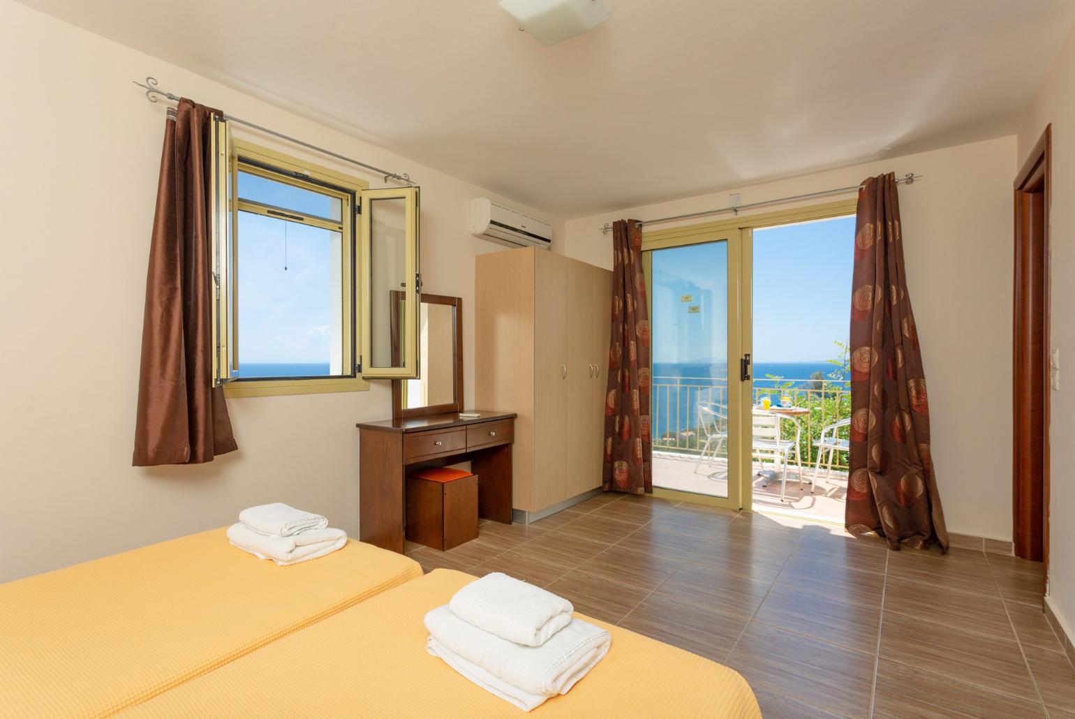 Twin bedroom with en suite bathroom and balcony access
