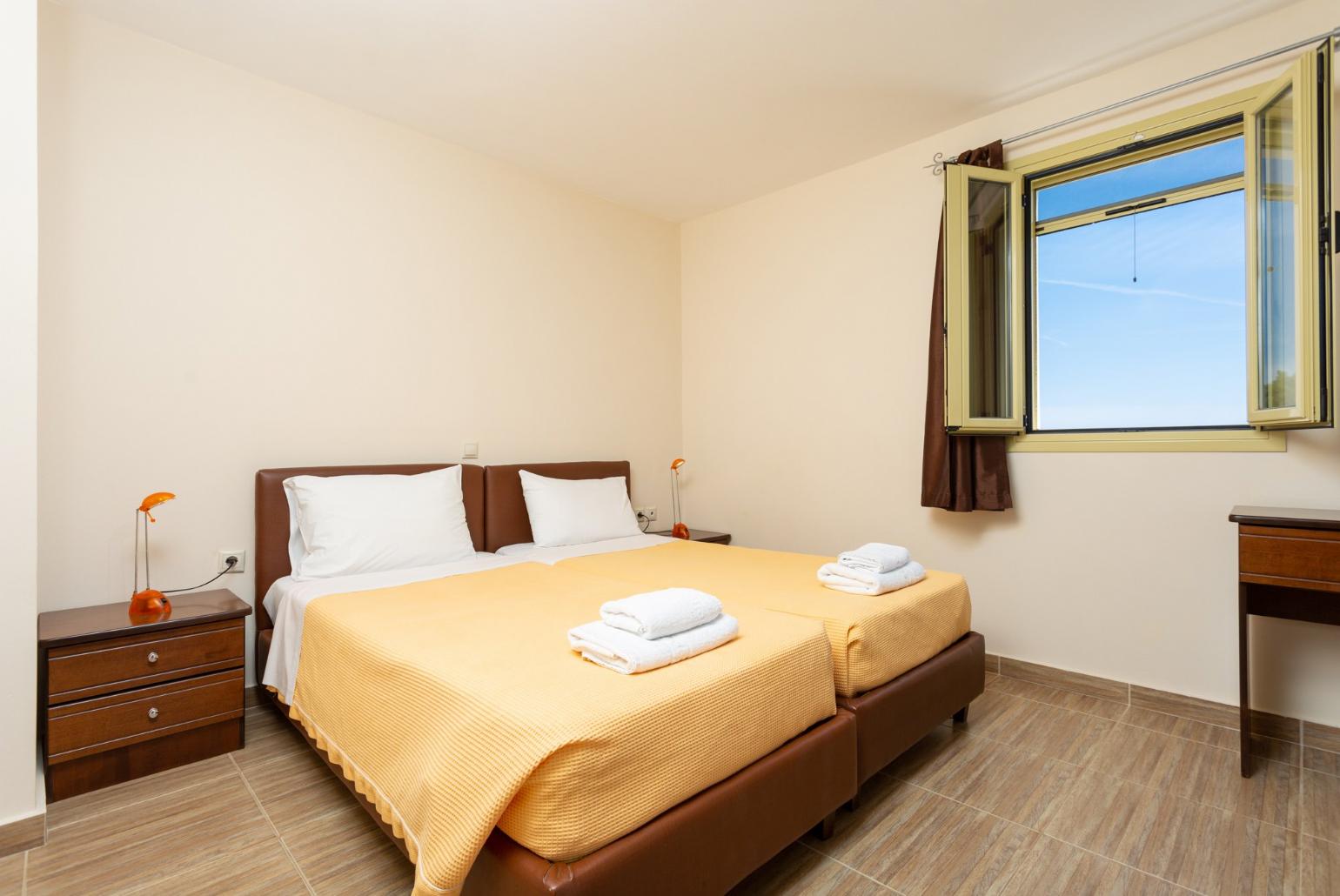 Twin bedroom with en suite bathroom and balcony access