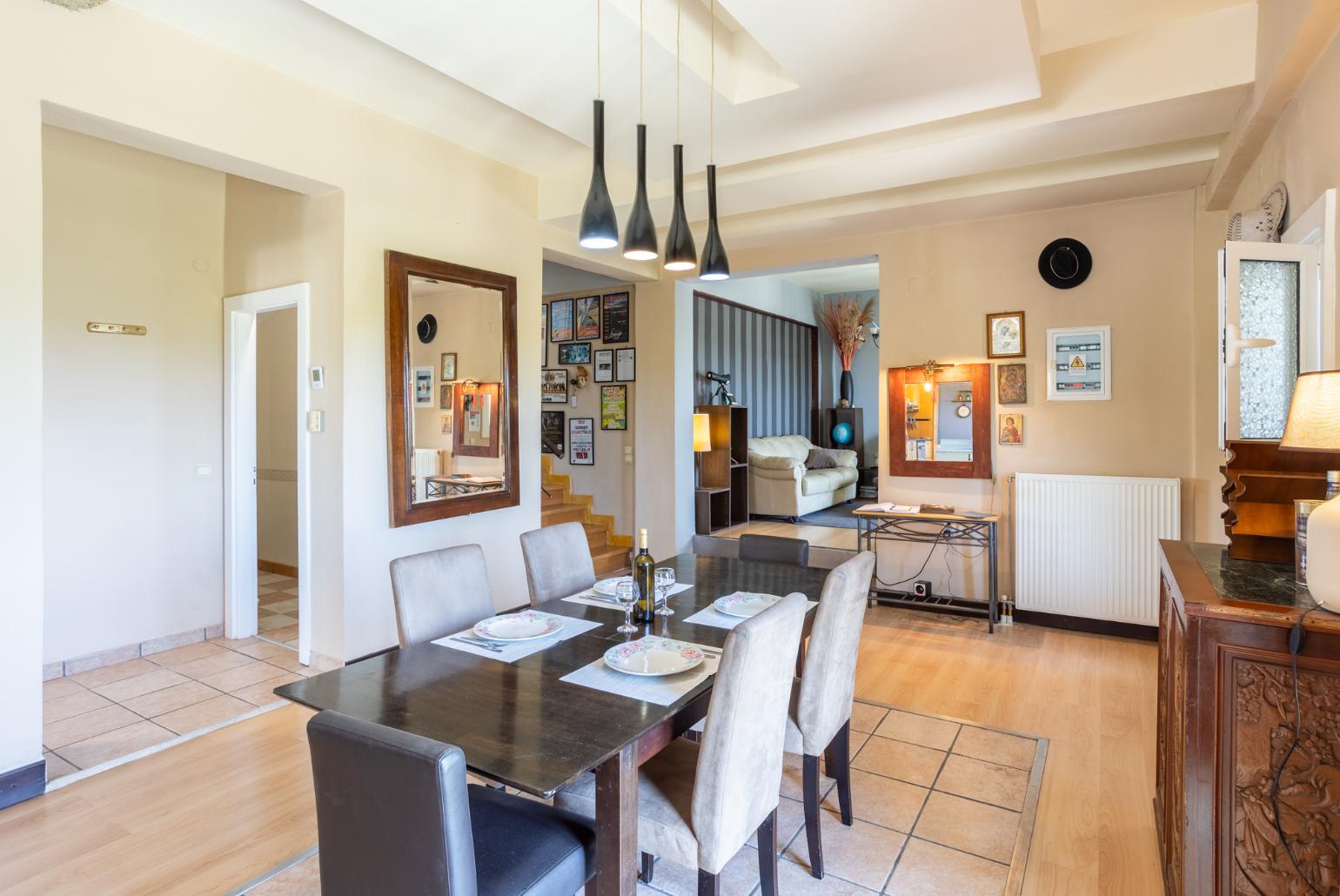 Open-plan living room with sofas, dining area, kitchen, ornamental fireplace, WiFi internet, and satellite TV