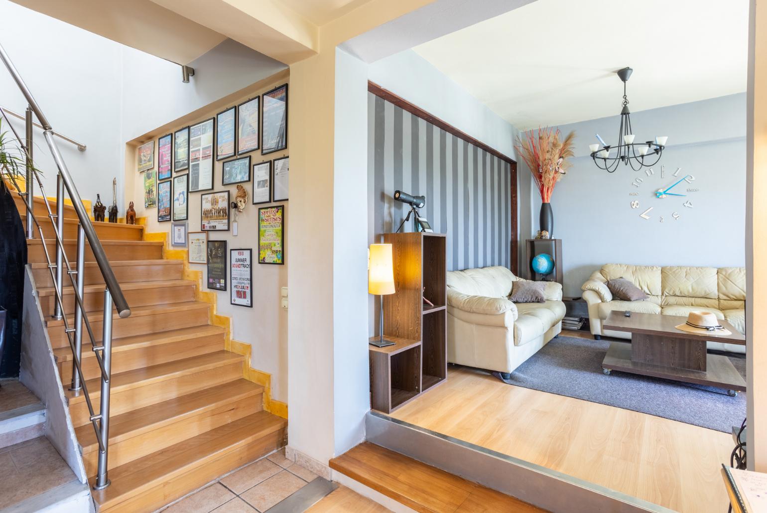 Open-plan living room with sofas, dining area, kitchen, ornamental fireplace, WiFi internet, and satellite TV