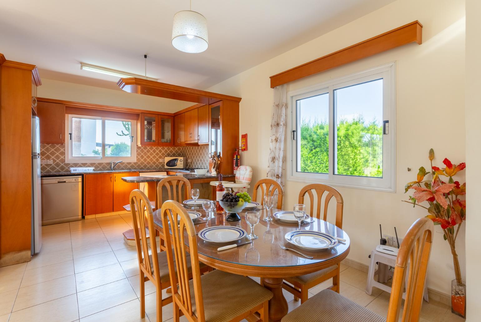 Open-plan living room with sofas, dining area, kitchen, WiFi internet, satellite TV, and terrace access