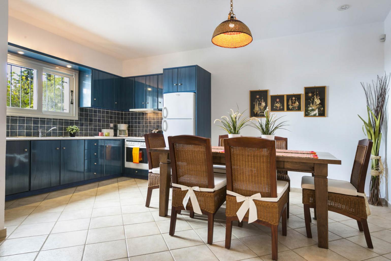 Open-plan living room with sofas, dining area, equipped kitchen, ornamental fireplace, A/C, WiFi internet, satellite TV, DVD player, and terrace access