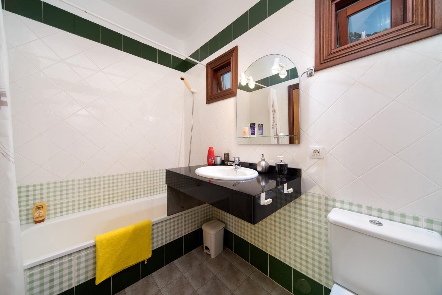Bathroom with bath and overhead shower