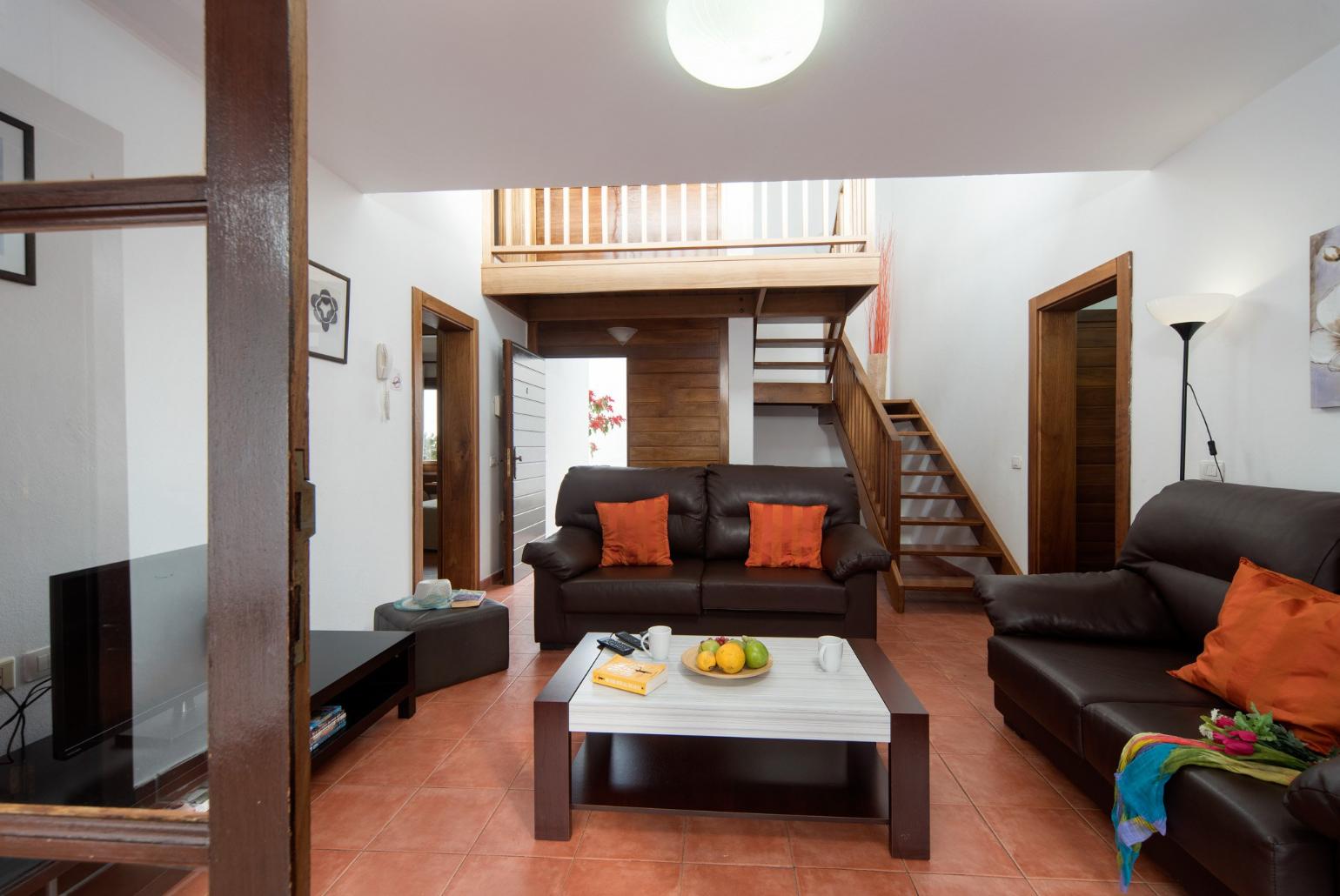 Living room with sofas, WiFi internet, satellite TV, and terrace access