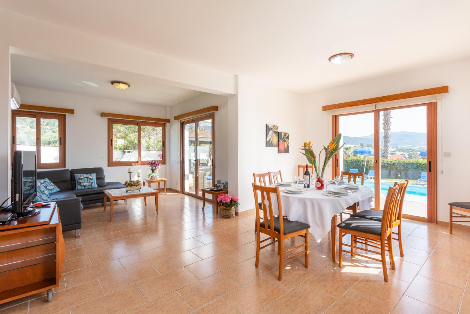 Open-plan living room with sofa, dining area, kitchen, A/C, WiFi internet, satellite TV, and sea views