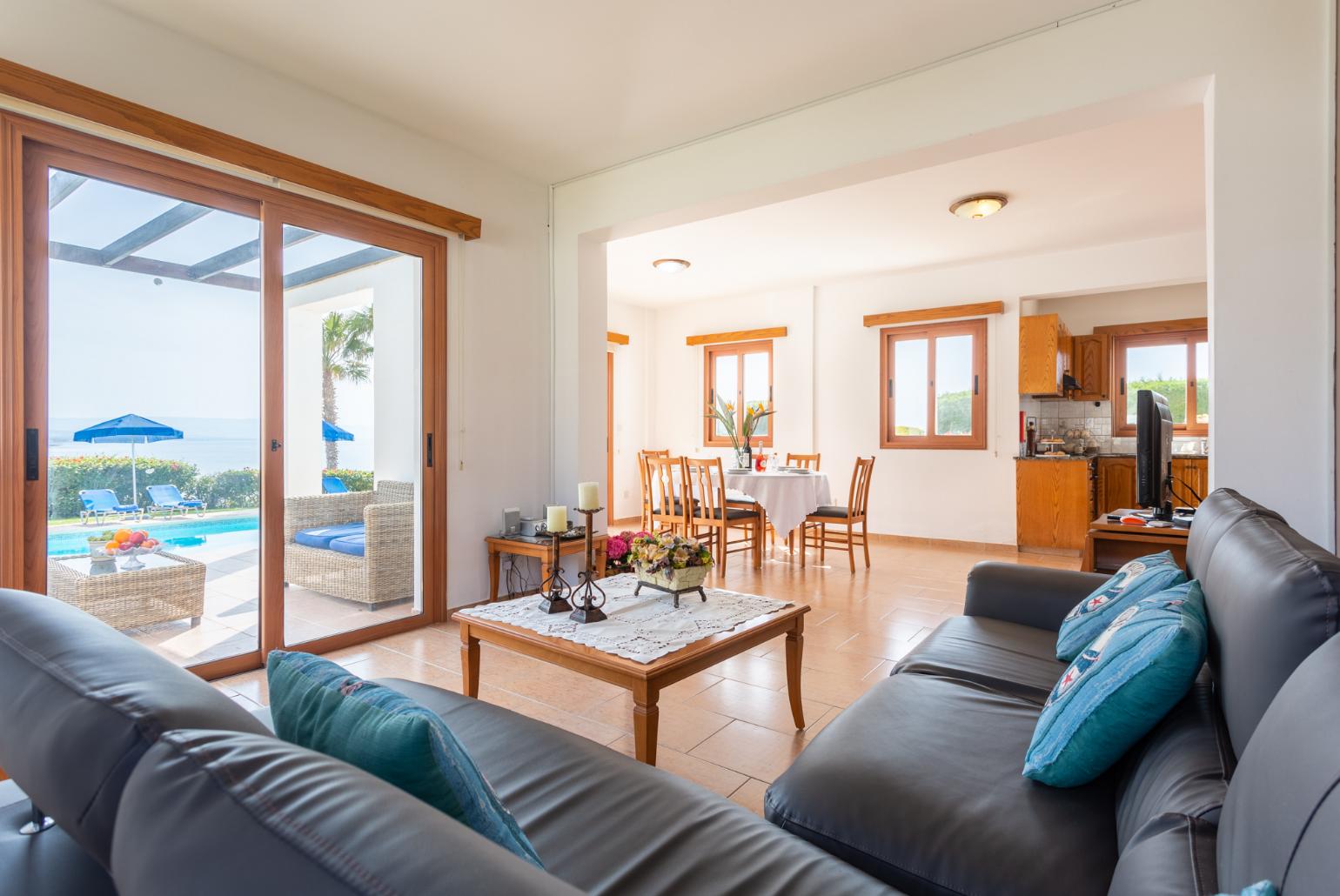 Open-plan living room with sofa, dining area, kitchen, A/C, WiFi internet, satellite TV, and sea views