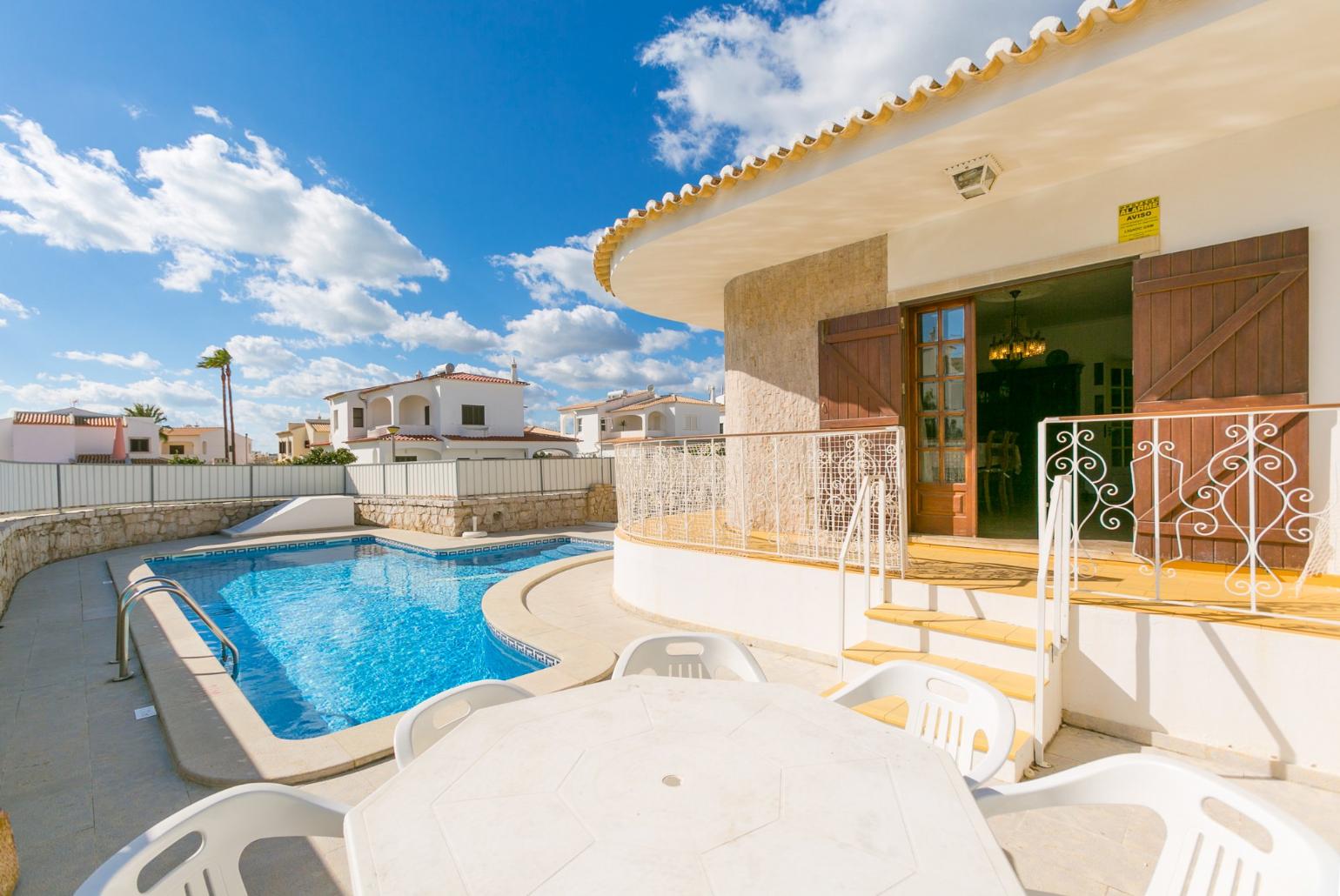 Pool area with sunbeds and outdoor table
