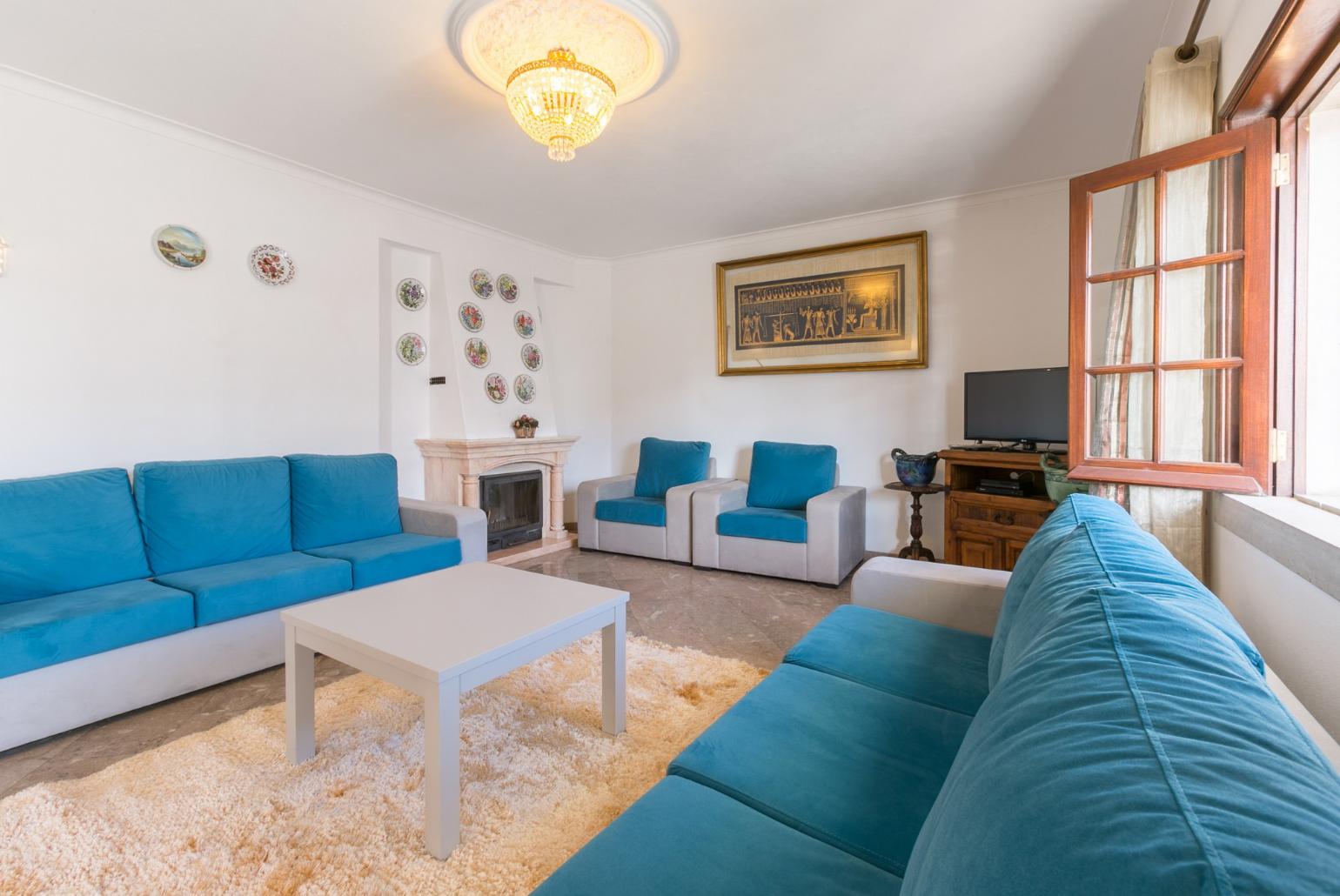 Living room with ornamental fireplace and TV