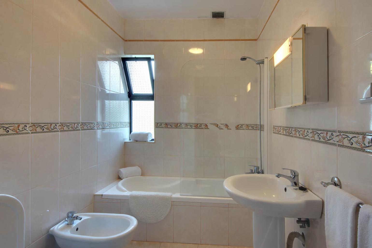 Bathroom with bath and shower