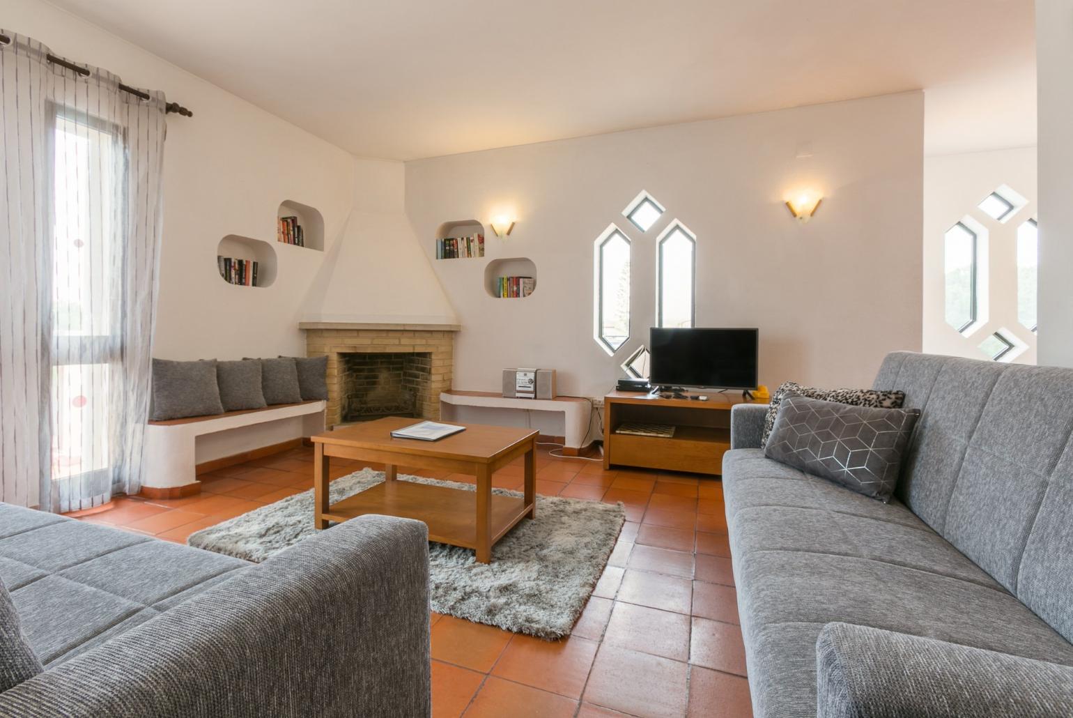 Living room with sofas, dining area, ornamental fireplace, WiFi internet, satellite TV, and DVD player